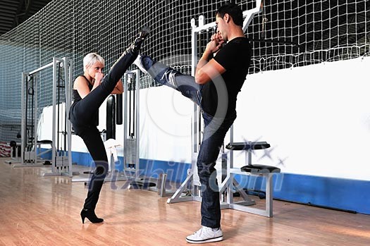 woman in the fitness gim working out with personal trainer coach woman in the fitness gim working out with personal trainer coach