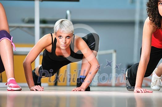 group of women working out in fitness club group of women working out in fitness club