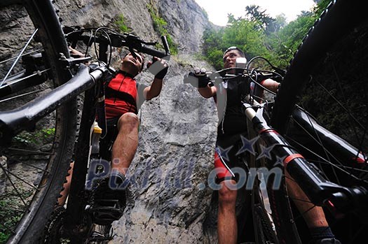 two friends have fun outdoor in nature and representing concept of healthy life and fitnes on muntain bike two friends have fun outdoor in nature and representing concept of healthy life and fitnes on muntain bike