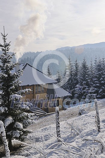 wooden winter house at early morning