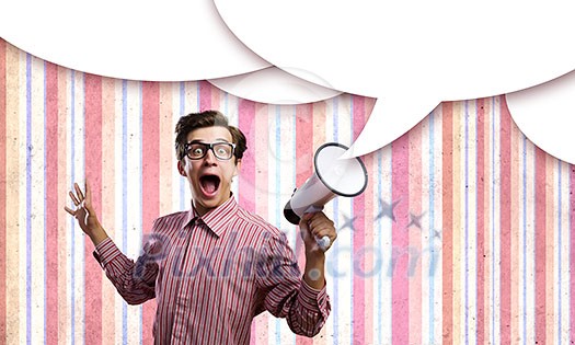 Young man in casual screaming in megaphone Young man in casual screaming in megaphone