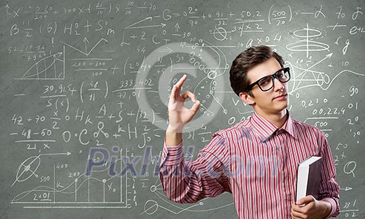 Young funny man in glasses against chalk blackboard Young funny man in glasses against chalk blackboard