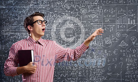 Young funny man in glasses against chalk blackboard Young funny man in glasses against chalk blackboard
