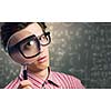 Young man scientist looking in magnifying glass