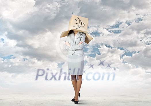 Businesswoman wearing carton box with sign on head Businesswoman wearing carton box with sign on head