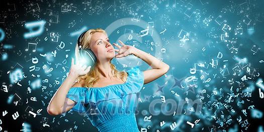 Young blond girl in blue dress listening music