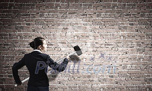 Young attractive businesswoman with hammer in hands Young attractive businesswoman with hammer in hands