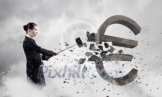Young businesswoman crashing with hammer stone euro symbol