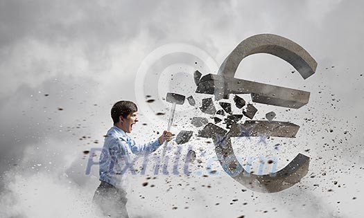 Young businessman crashing with hammer stone euro symbol Young businessman crashing with hammer stone euro symbol