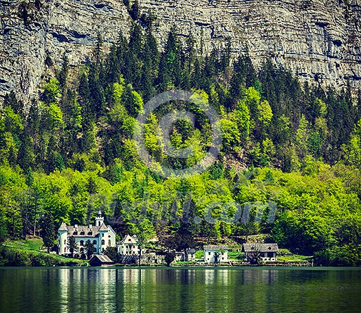 Vintage retro effect filtered hipster style travel image of castle at Hallstatter See mountain lake in Austria. Salzkammergut region, Austria