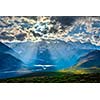 HImalayan valley landscape with Himalayas mountains. Sun rays come through clouds. Himachal Pradesh, India