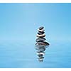 Zen meditation background -  balanced stones stack in water with reflection