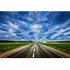 Travel concept background - road under dramatic stormy cloudy sky