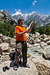 Hiker trekker studying map route on trek in Himalayas mountains. Himachal Pradesh,India