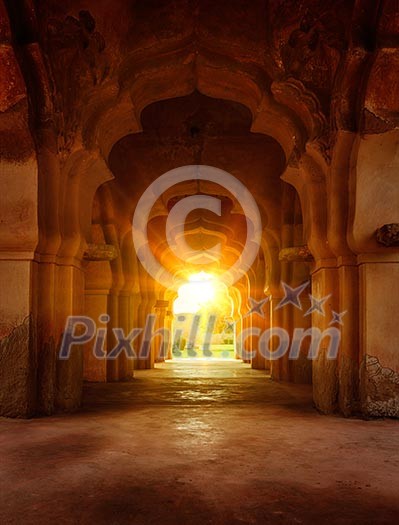 Old ruined arch in ancient palace at sunset, India