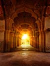 Old ruined arch in ancient palace at sunset, India