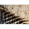Abstract - stairs casting shadow on old weathered wall