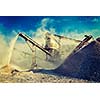 Vintage retro effect filtered hipster style image of Industrial background - crusher rock stone crushing machine at open pit mining and processing plant for crushed stone, sand and gravel