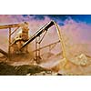 Vintage retro effect filtered hipster style image of Industrial background - crusher rock stone crushing machine at open pit mining and processing plant for crushed stone, sand and gravel