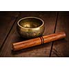 Tibetan buddhist singing bowl, rin gong, Himalayan bowl or suzu gong for  meditation, music, relaxation, and personal well-being with mallet on wooden background
