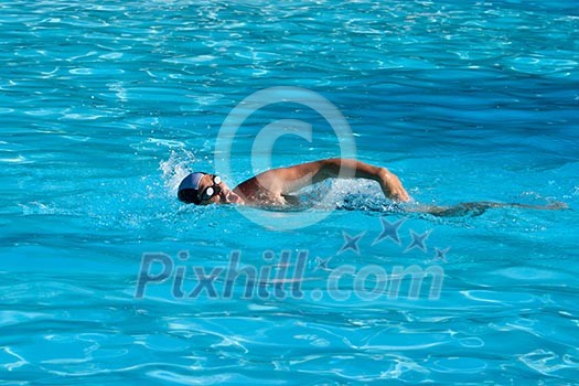 Athletic Man swimming in the pool Athletic Man swimming in the pool