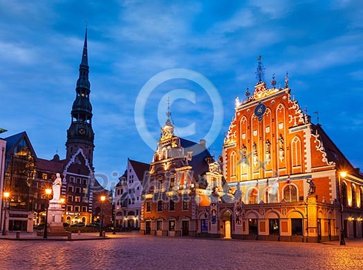 Riga Town Hall Square, House of the Blackheads, St. Roland Statue and St. Peter's Church illuminated in the evening, Riga, Latvia