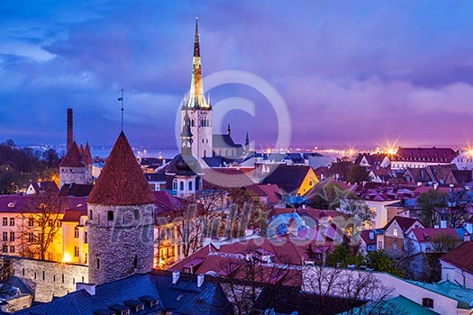 Aerial view of Tallinn Medieval Old Town illuminated in evening twilight, with dramatic sky Estonia Aerial view of Tallinn Medieval Old Town illuminated in evening twilight, with dramatic sky Estonia