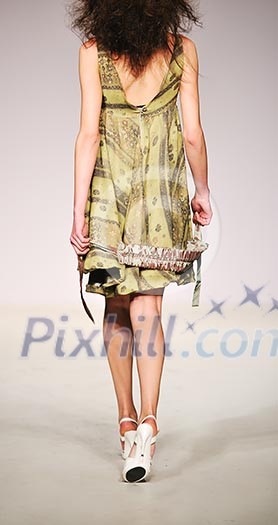 young beautiful model walking on fashion show piste