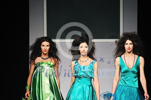 young beautiful model walking on fashion show piste