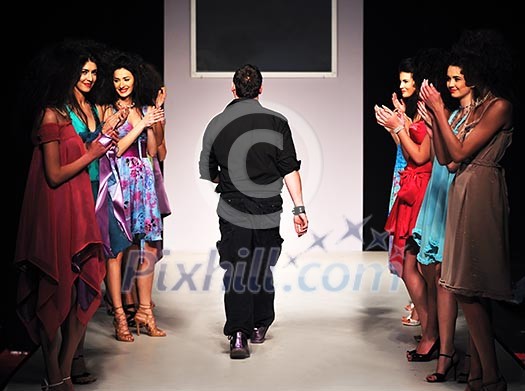 young successful fashion designer on the end of fashion show young successful fashion designer on the end of fashion show