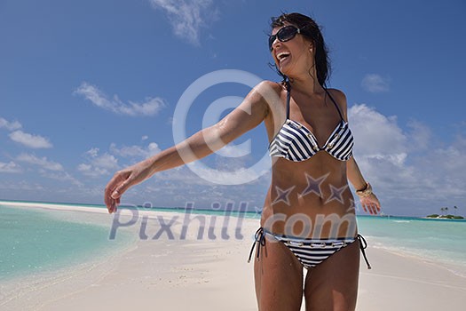 beautiful and happy young woman on beach have fun and relax on summer vacation over the crystal clear sea beautiful and happy young woman on beach have fun and relax on summer vacation over the crystal clear sea