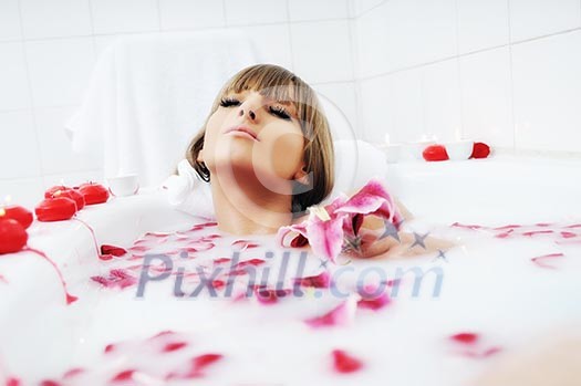 woman beauty spa and wellness treathment with red flower petals in bath woman beauty spa and wellness treathment with red flower petals in bath