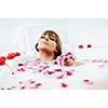 woman beauty spa and wellness treathment with red flower petals in bath