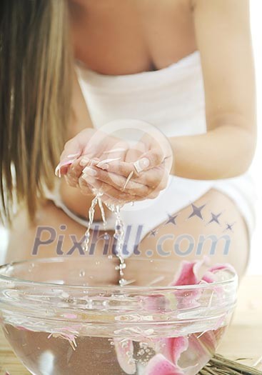 hand spa and beauty treatment with aroma and flowers in water