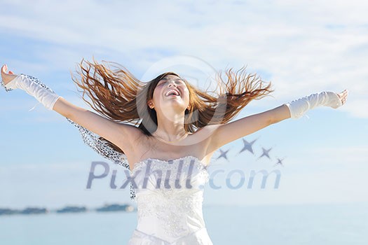 asian  bride with a veil on the beach in the sky and blue sea. honeymoon on the fantastic island at summer