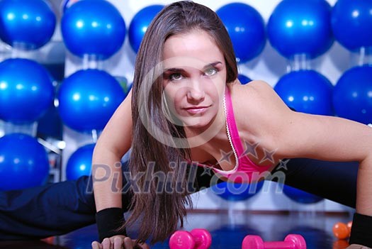 young pretty woman exercising in a fitness center young pretty woman exercising in a fitness center