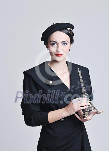 beautiful young woman hold paris symbol eiffel tower isolated on white background and representing travel and tourist concept