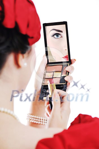 beautiful young pinup woman apply makeup and cosmetics beauty treatment isolated on white in studio beautiful young pinup woman apply makeup and cosmetics beauty treatment isolated on white in studio