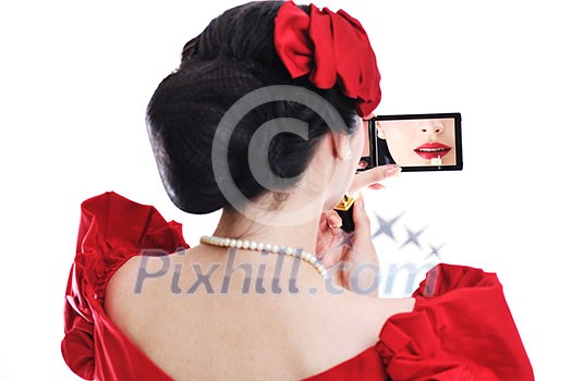 beautiful young pinup  woman apply makeup and cosmetics beauty treatment isolated on white in studio