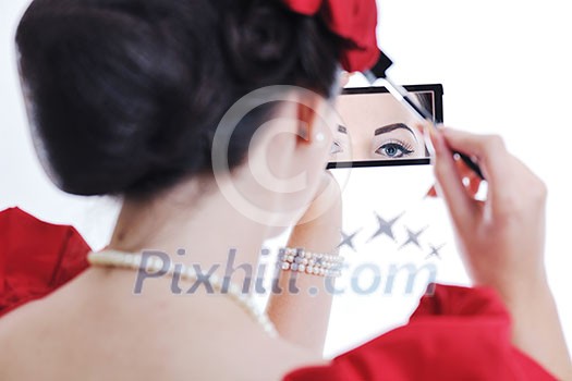 beautiful young pinup woman apply makeup and cosmetics beauty treatment isolated on white in studio beautiful young pinup woman apply makeup and cosmetics beauty treatment isolated on white in studio