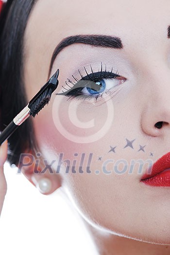 beautiful young pinup woman apply makeup and cosmetics beauty treatment isolated on white in studio beautiful young pinup woman apply makeup and cosmetics beauty treatment isolated on white in studio