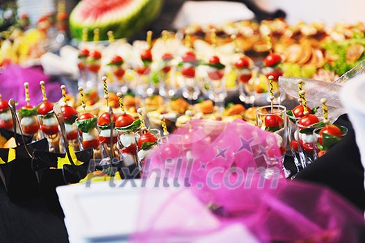 buffed food closeup of  fruits, vegetables, meat and fish arranged on banquet table