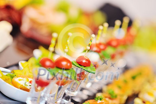 buffed food closeup of  fruits, vegetables, meat and fish arranged on banquet table