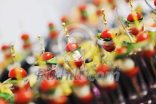 buffed food closeup of  fruits, vegetables, meat and fish arranged on banquet table