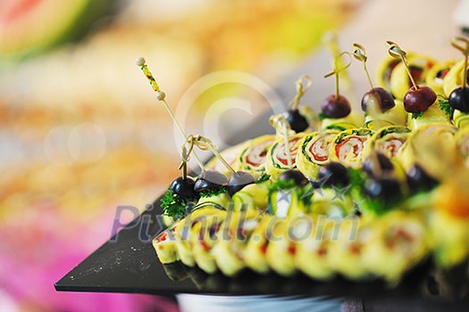 buffed food closeup of  fruits, vegetables, meat and fish arranged on banquet table