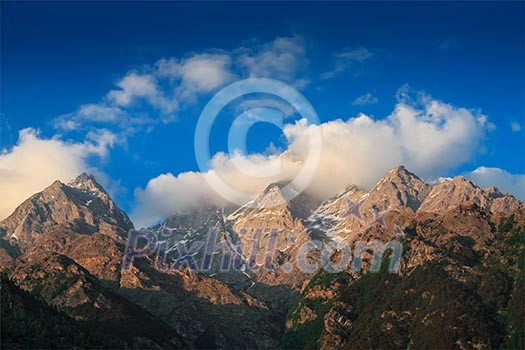 Himalayas mountain top summits in clouds on sunset