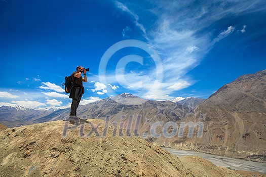 Photographer taking photos in Himalayas mountains. Spiti valley, Himachal Pradesh, India