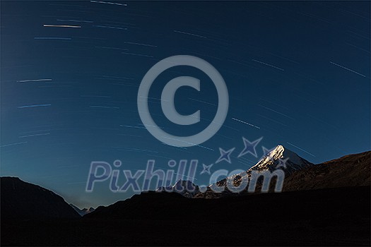 Star trails above Himalayas mountains in night.