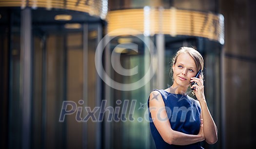 Pretty, young businesswoman talking on the phone in front of a modern building in Manhattan (shallow DOF; color toned image) Pretty, young businesswoman talking on the phone in front of a modern building in Manhattan (shallow DOF; color toned image)