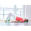 Pretty young woman doing YOGA exercise at home